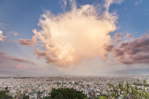 A cloud explodes with color over Kathmandu, Nepal