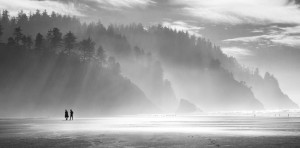 Two people take a stroll on the beach at Neskowin, Oregon